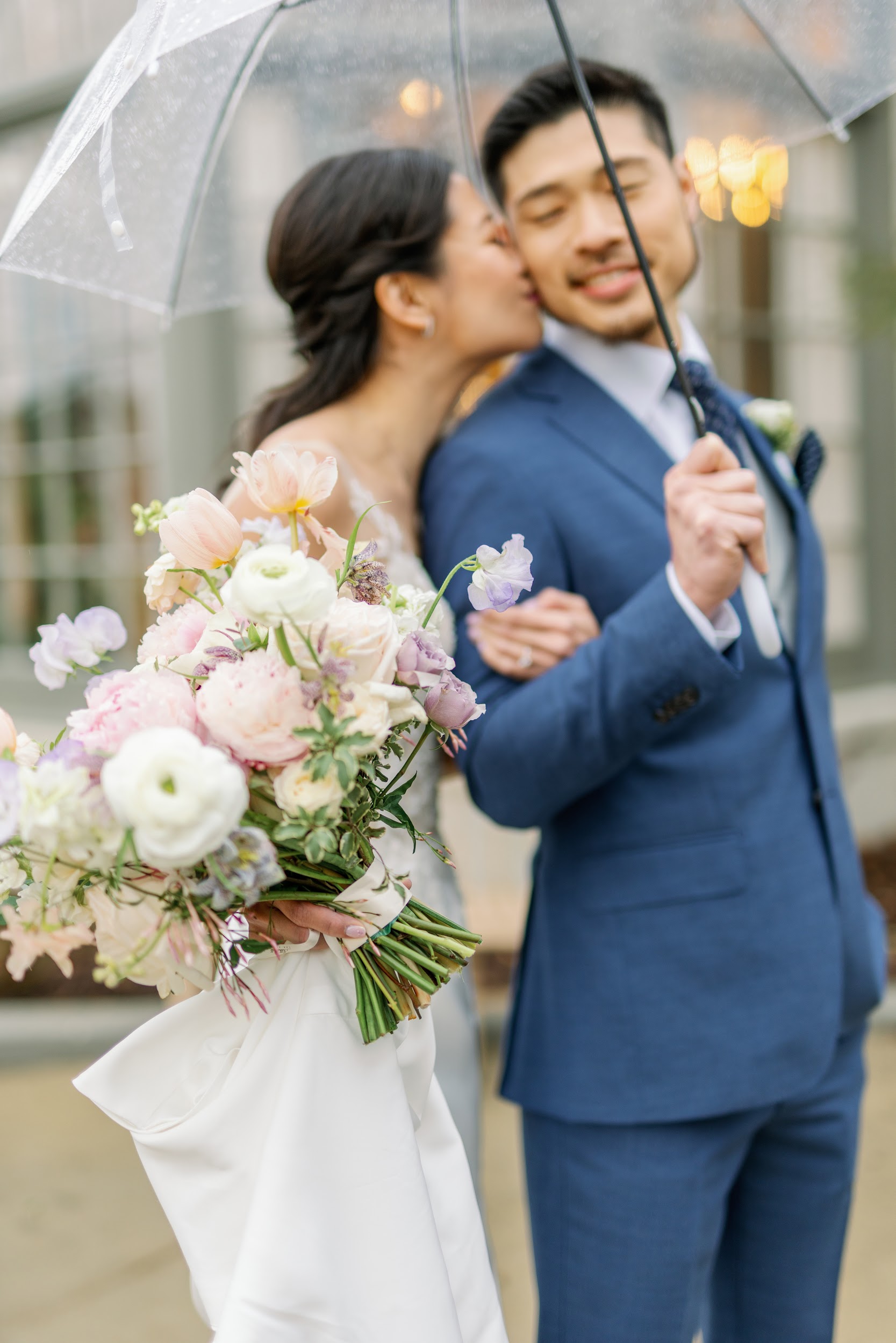 Couple with lush bridal bouquet